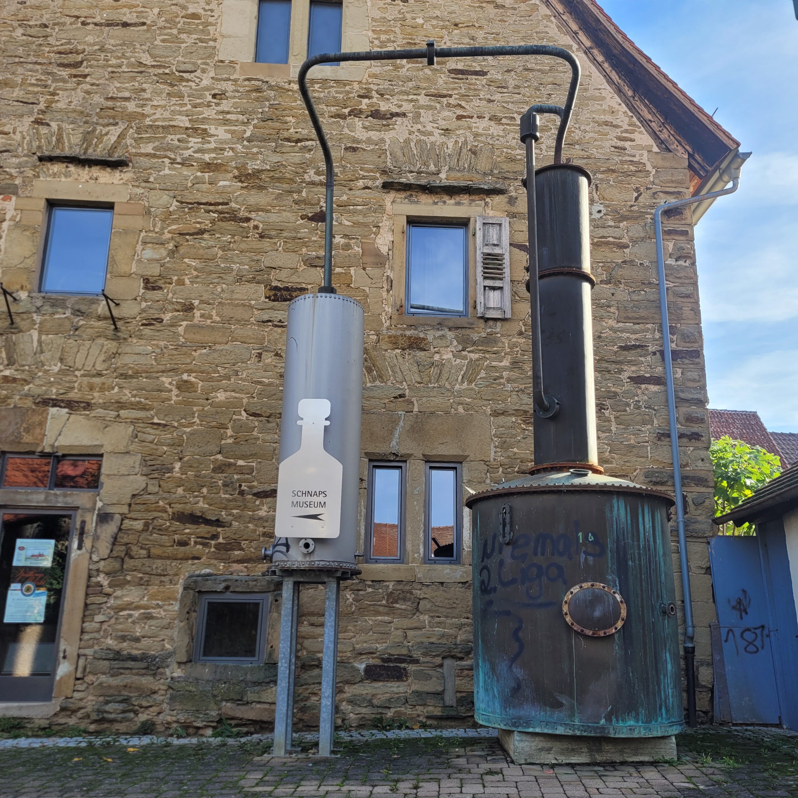 Vor dem Schnapsmuseum Bönnigheim ist an der Hauswand eine imposante und Haushohe Destille angebracht.